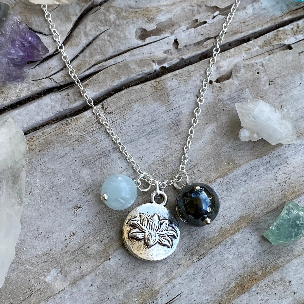 Lotus Charm Necklace with with Hematite and Aquamarine for awakening to the spiritual reality of life